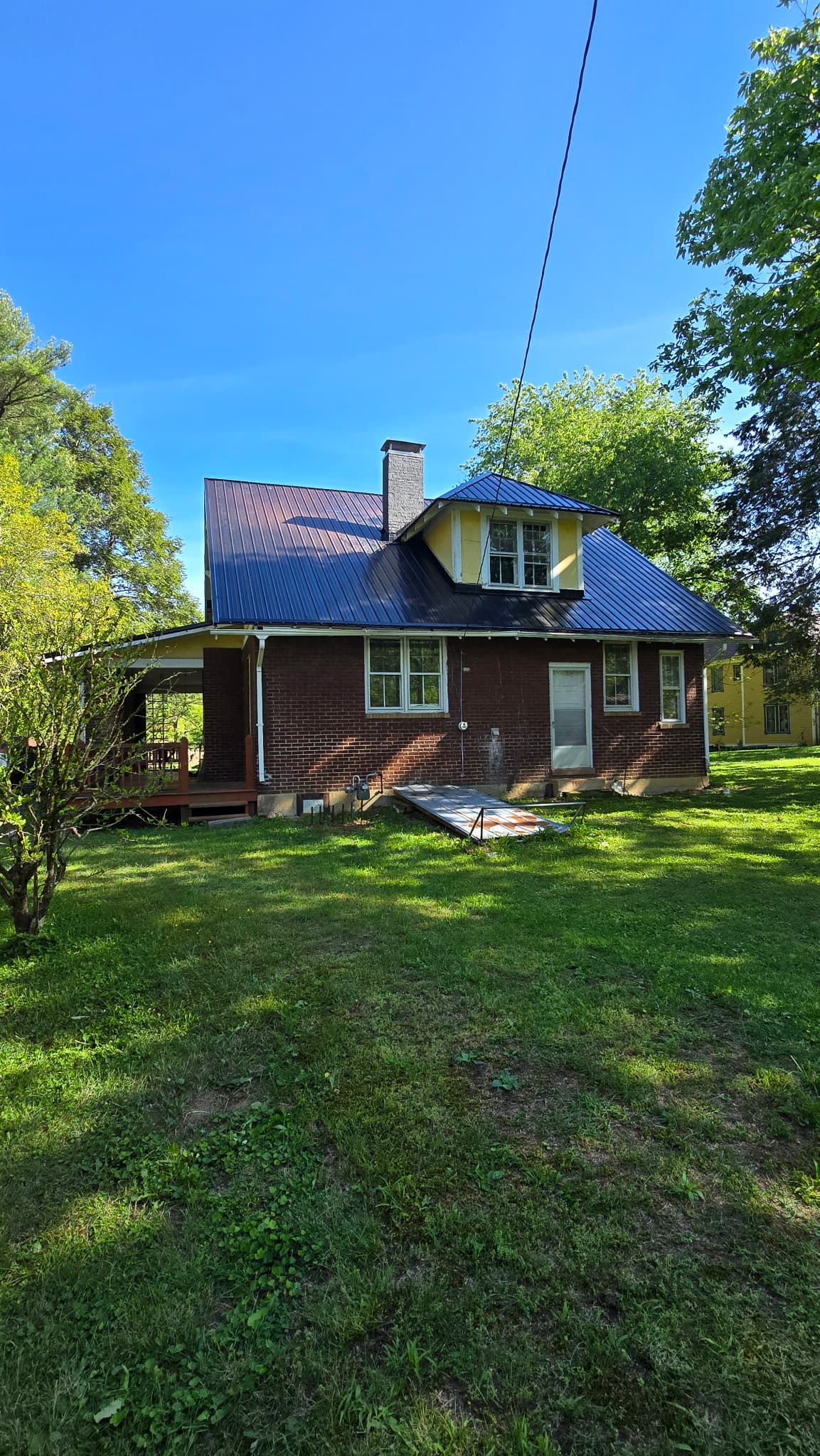 New blue metal roof on a two-story brick home