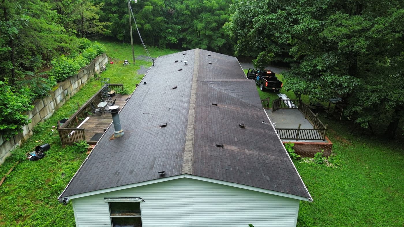Before — a worn-out asphalt shingle roof due for replacement